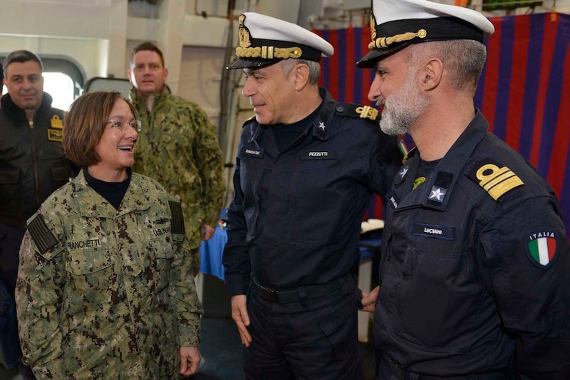Admirals speak aboard Italian ship.