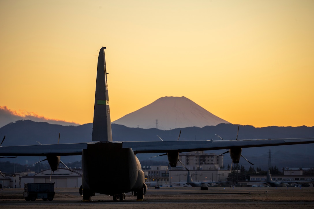 Aircraft sits on runway with Mount Fuji in background.