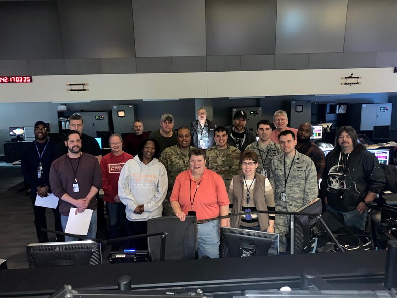 Members of the 50th Operations Group detachment 1 and the National Oceanic and Atmospheric Administration Satellite Operations Facility commemorate the successful decommissioning of Meteorological Satellite Program Flight 14 at the Nation Oceanic and Atmospheric Administration Satellite Operations Facility in Suitland, Maryland. DMSP-14 had an original design life of three to five years, and far exceeded expectations when it was finally retired after 22 years of service.