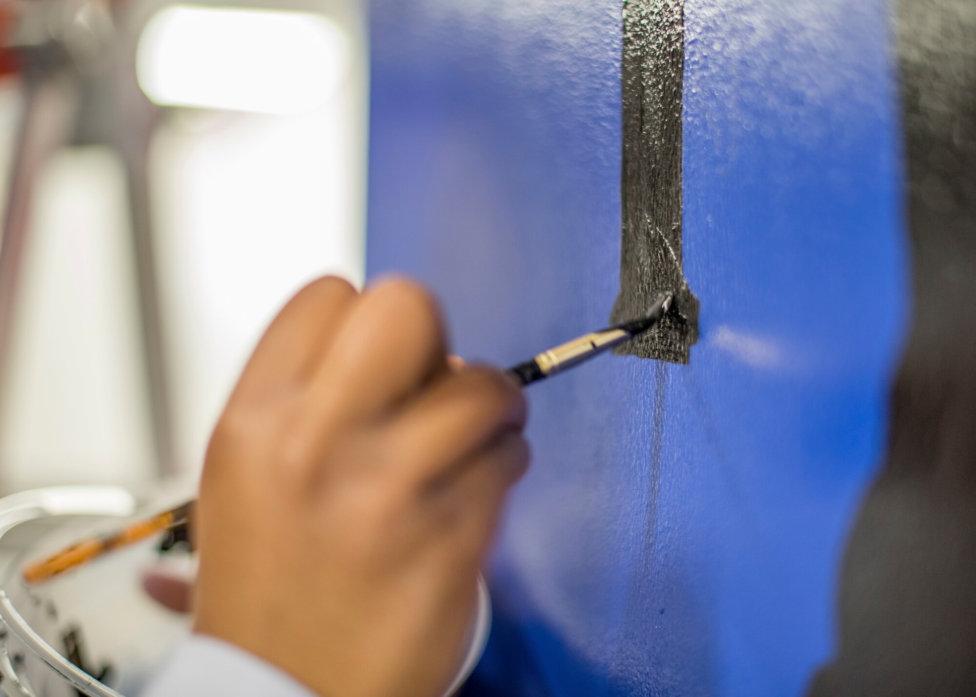 Airman 1st Class Te’Anne Dailey, 374th Security Forces Squadron patrolman, paints a mural at a main lobby of SFS’s building at Yokota Air Base, Japan, Feb. 7, 2020