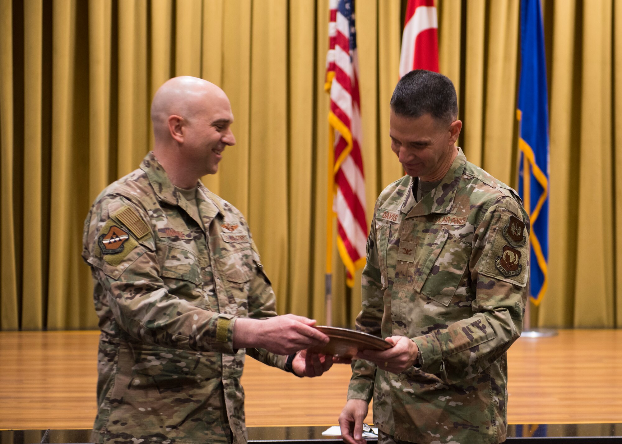 U.S. Air Force Col. John W. Hawkins, 39th Air Base Wing vice commander (left) presents U.S. Air Forces in Europe and Air Forces Africa Command Chaplain Col. Trent Davis (right) with a gift, Feb. 20, 2020, at Incirlik Air Base, Turkey. Both English and Turkish writing was engraved on the copper-plated memento to express appreciation for his words during the 2020 National Prayer Breakfast. (U.S. Air Force photo by Senior Airman Matthew Angulo)