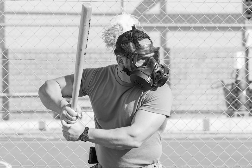 A U.S. Army Soldier, with 655 Regional Support Group, 316 Sustainment Command (Expeditionary), 377 Theater Sustainment Command, prepares to hit a ball during a game of gas mask baseball Feb. 12, 2020 at Joint Training Center-Jordan, paying tribute to former service members who used the sport to train for chemical warfare during WWI. We still have the greatest Army in the world. We serve the people of the United States and we are going to protect them with our lives if that is what it comes to. (U.S. Army photo by Sgt. 1st Class Shaiyla B. Hakeem)