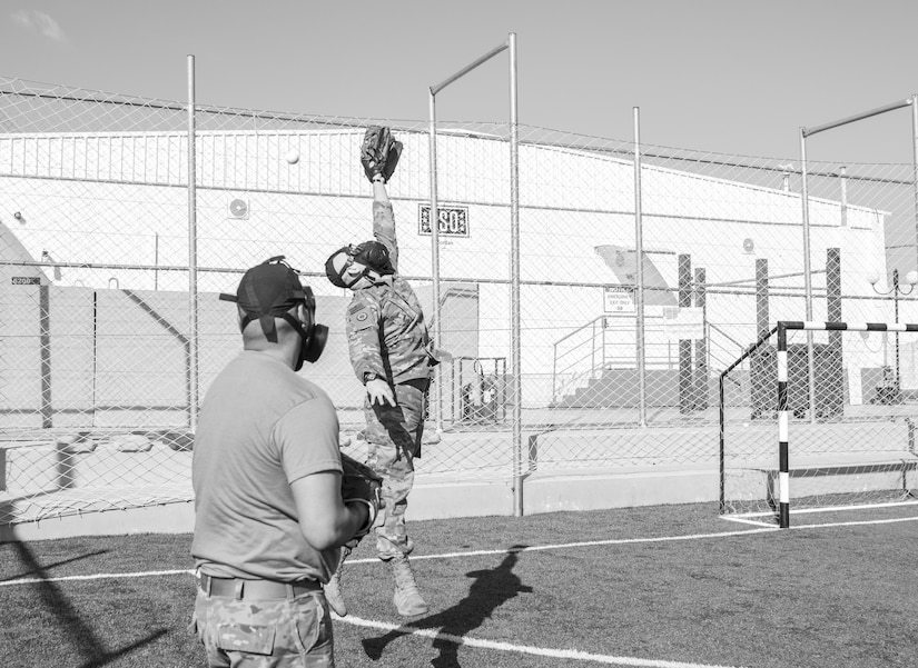 U.S. Army Soldiers, with 655 Regional Support Group, 316 Sustainment Command (Expeditionary), 377 Theater Sustainment Command, warm up before a game of gas mask baseball Feb. 12, 2020 at Joint Training Center-Jordan, paying tribute to former service members who used the sport to train for chemical warfare during WWI. We still have the greatest Army in the world. We serve the people of the United States and we are going to protect them with our lives if that is what it comes to. (U.S. Army photo by Sgt. 1st Class Shaiyla B. Hakeem)