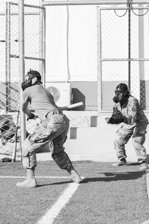 A U.S. Army Soldier, with 655 Regional Support Group, 316 Sustainment Command (Expeditionary), 377 Theater Sustainment Command, prepares to swing at a ball during a game of gas mask baseball Feb. 12, 2020 at Joint Training Center-Jordan, paying tribute to former service members who used the sport to train for chemical warfare during WWI. We still have the greatest Army in the world. We serve the people of the United States and we are going to protect them with our lives if that is what it comes to. (U.S. Army photo by Sgt. 1st Class Shaiyla B. Hakeem)