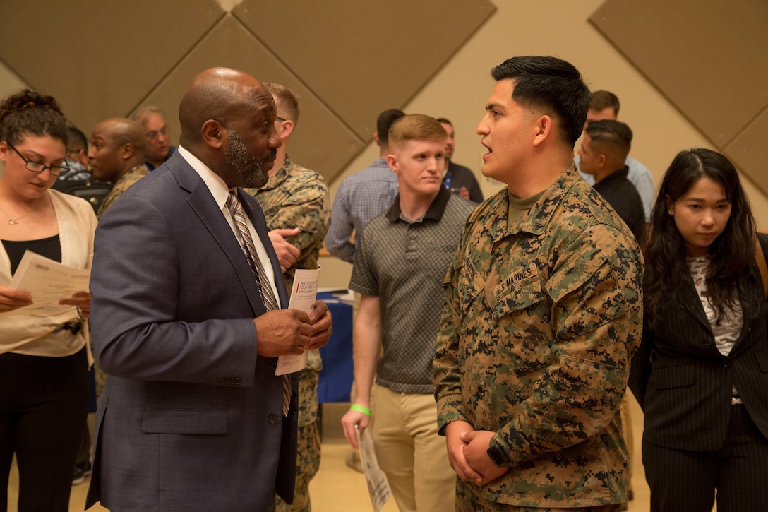 Retired U.S. Marine Corps Sergeant Major of the Marine Corps Ronald L. Green speaks with U.S. Marine Corps Cpl. Luis F. Garcia, an inventory management specialist with 3rd Marine Division, at the Hiring Our Heroes Career Summit at Camp Foster, Okinawa, Japan, Feb. 25, 2020. The summit was held to help service members and their families transition out of the U.S. armed forces. (U.S. Marine Corps photo by Lance Cpl. Zachary Larsen)