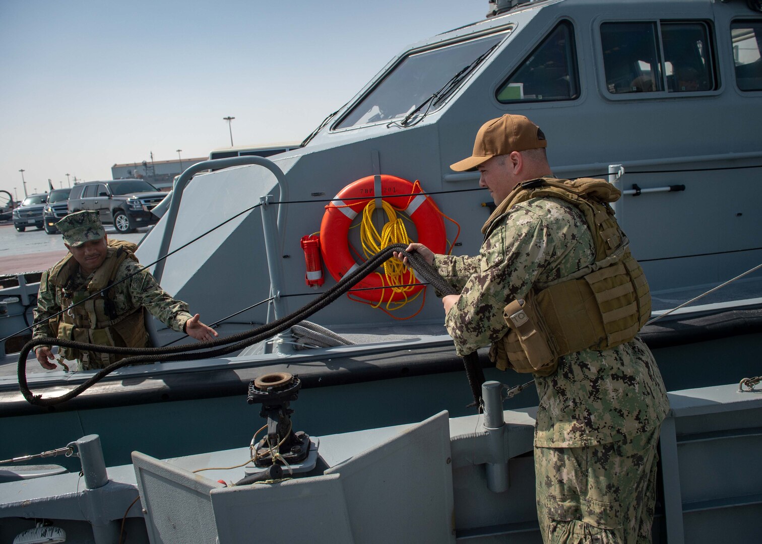 JUBAIL, Kingdom of Saudi Arabia 200223-N-JO908-1123
Sailors assigned to Commander, Task Force 56 secure mooring lines as a Mark VI patrol boat moors pierside in Jubail, Kingdom of Saudi Arabia for exercise Nautical Defender 20 (ND) Feb. 23. ND is a bilateral maritime exercise between the U.S. Navy and the Royal Saudi Naval Forces (RSNF) designed to build and sustain warfighting capabilities, support long term regional security and enhance military-to-military interoperability with the U.S. and Kingdom of Saudi Arabia. (U.S. Navy photo by Mass Communication Specialist 1st Class Kory Alsberry)