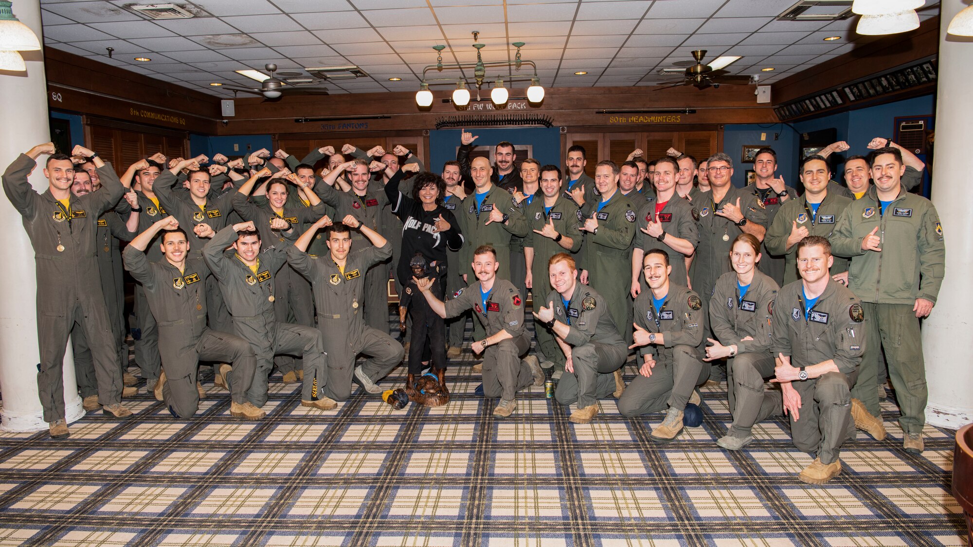 Janine Sijan-Rozina, Capt. Lance P. Sijan’s sister, and 8th Fighter Wing F-16 Fighting Falcon pilots pose for a group photo at Kunsan Air Base, Republic of Korea, Feb. 21, 2020. Sijan-Rozina visited the Wolf Pack to share her brother’s inspiring story about resiliency, survival and his legacy which posthumously earned him the Medal of Honor.  (U.S. Air Force photo by Senior Airman Jessica Blair)