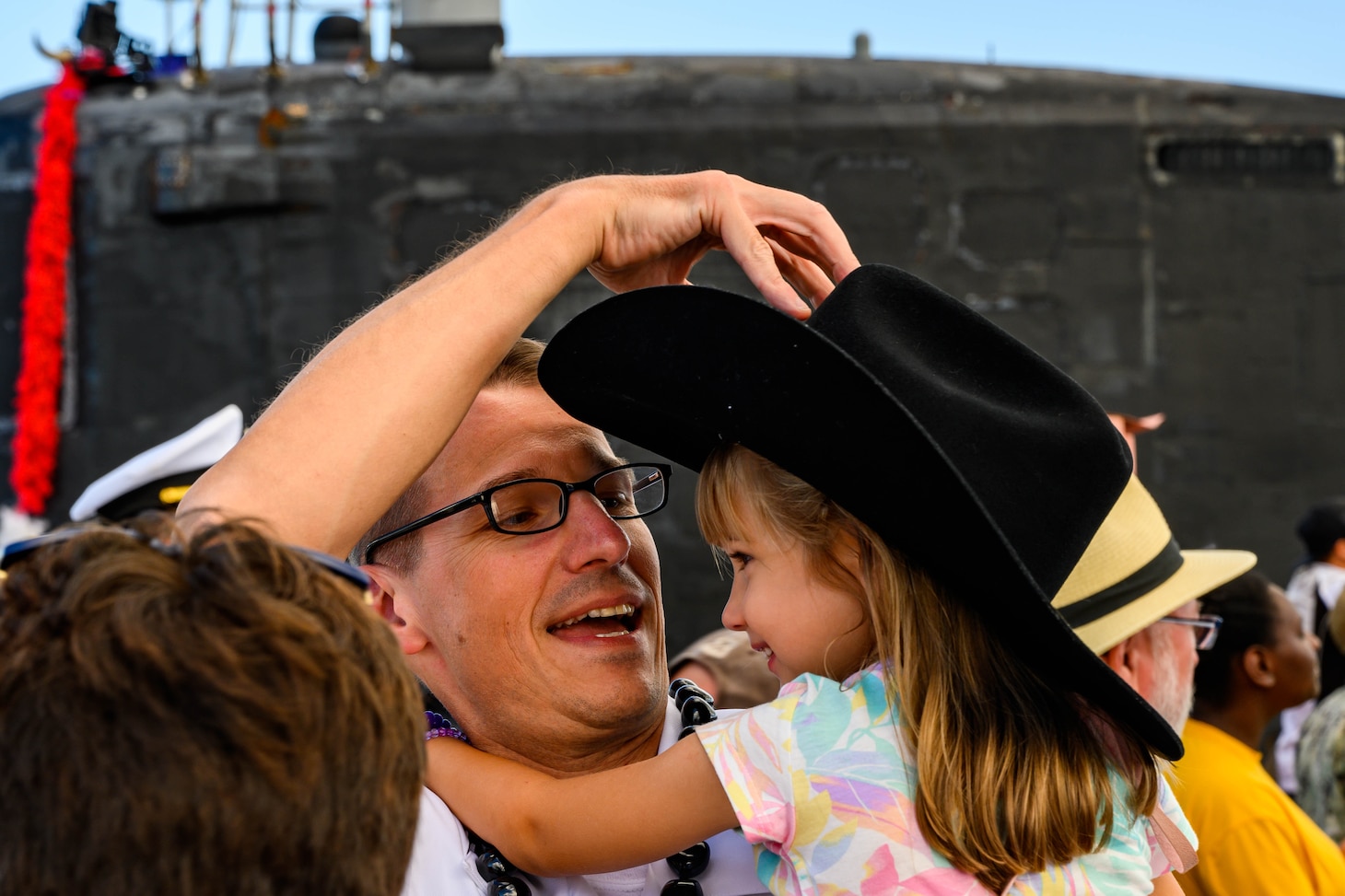 Cmdr. Mike Dolbec, from Manchester, New Hampshire, commanding officer of the Virginia-class fast-attack submarine USS Texas (SSN 775), greets his family during Texas' homecoming. Texas performed a full spectrum of operations, including anti-submarine and anti-surface warfare, during the seven-month Indo-Pacific deployment. (U.S. Navy photo by Mass Communication Specialist 1st Class Michael B. Zingaro/Released)