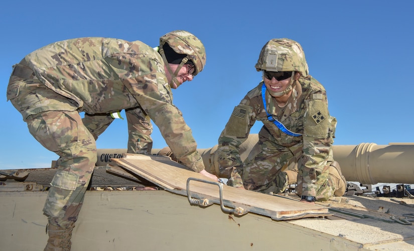 Pvt. Shawn Keiser, (left) a M1 Abrams tank system maintainer assigned to the 1st Battalion, 68th Armored Regiment, and Pfc. Jenicelee David – Rodrigues a M1 abrams tank system maintainer assigned to the 4th Squadron, 10th Cavalry Regiment, both from Fort. Carson, Colorado, change the battery out of an M1 Abrams System Enhancement Package v2 tank at Joint Base Charleston’s Naval Weapons Station S.C., Feb 14, 2020. The 841st Transportation Battalion and the 3rd Armored Brigade Combat Team partnered to off load equipment from the shipping vessel Green Lake for a return to home station. The cargo was diverted to Joint Base Charleston and other ports on the east coast because of congestion at the Port of Beaumont, Texas. The 841st TB enables innovation and rapid global mobility by having a wide network of subject matter experts available to help load, unload, and transport equipment worldwide safely and efficiently.