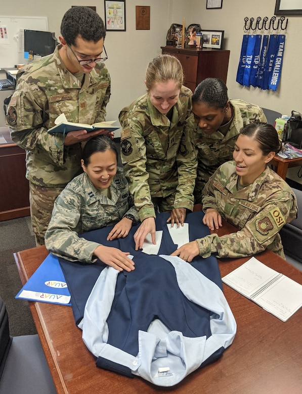 Air University Squadron Officer School students Capt. James Flores-Lombay, Capt. Jessica Sunkamaneevongse, Capt. Kristen Ricker, Capt. Tanisha Bramwell-Boose and Air Force Office of Special Investigations Special Agent Alexandra Garced signed up to take the Air University Advanced Research elective to research a redesign of the maternity service dress uniform. The Diversity and Inclusion topic of the elective also includes researching how to reimburse the cost of shipping mother’s milk home for female Airmen on short temporary duty assignments. The two topics are being studied at the request of the Air Force Women’s Initiative Team, which promotes diversity and inclusion in the Air Force. (Courtesy photo)