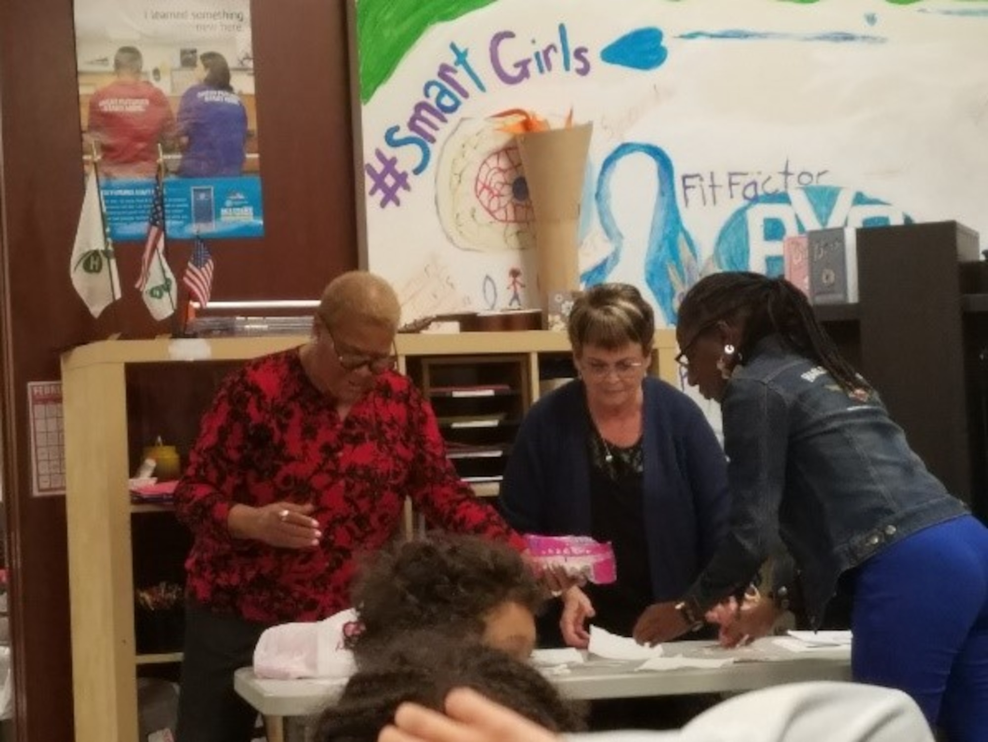 Juanita Rollins-Ecton, Beverley Knight-Stukenborg and Jacquelyn Griffin, all with the 88th Medical Group, package Valentine’s candy to pass out to the youth for their lesson on Teen Dating Violence. (U.S. Air Force photo/Laura McGowan)