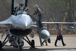 A pilot with the 36th Fighter Squadron steps down from the cockpit of an F-16 Falcon fighter jet in support of exercise Cobra Gold 2020 at Korat Royal Thai Air Force Base, Thailand, Feb. 24, 2020.