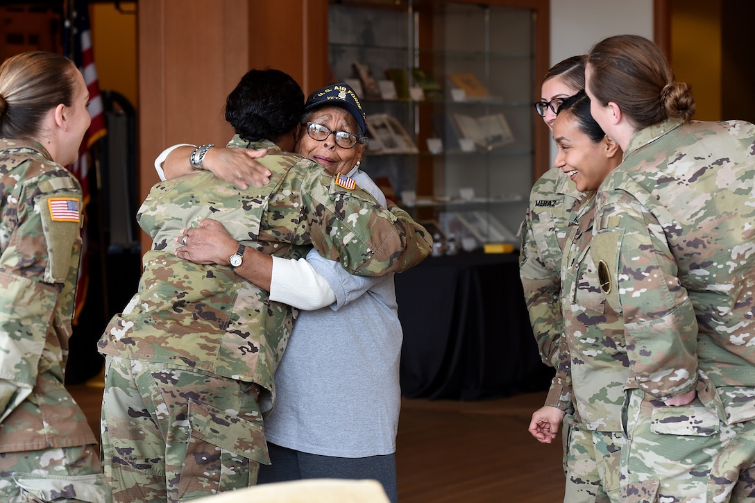 Amelia Cunningham, U.S. Air Force veteran, receives a hug from an Army Reserve Master Sgt. Lawanda Nelson during the Operation HerStory all-female Honor Flight news conference at Pritzker Military Library, in Chicago, February 25, 2020.