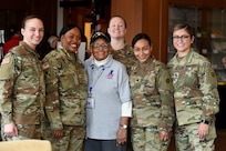 Amelia Cunningham, U.S. Air Force veteran, pauses for a photo with Army Reserve Soldiers, assigned to the 85th U.S. Army Reserve Support Command, during the Operation HerStory all-female Honor Flight news conference at Pritzker Military Library, in Chicago, February 25, 2020.