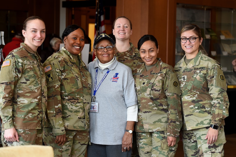 Amelia Cunningham, U.S. Air Force veteran, pauses for a photo with Army Reserve Soldiers, assigned to the 85th U.S. Army Reserve Support Command, during the Operation HerStory all-female Honor Flight news conference at Pritzker Military Library, in Chicago, February 25, 2020.