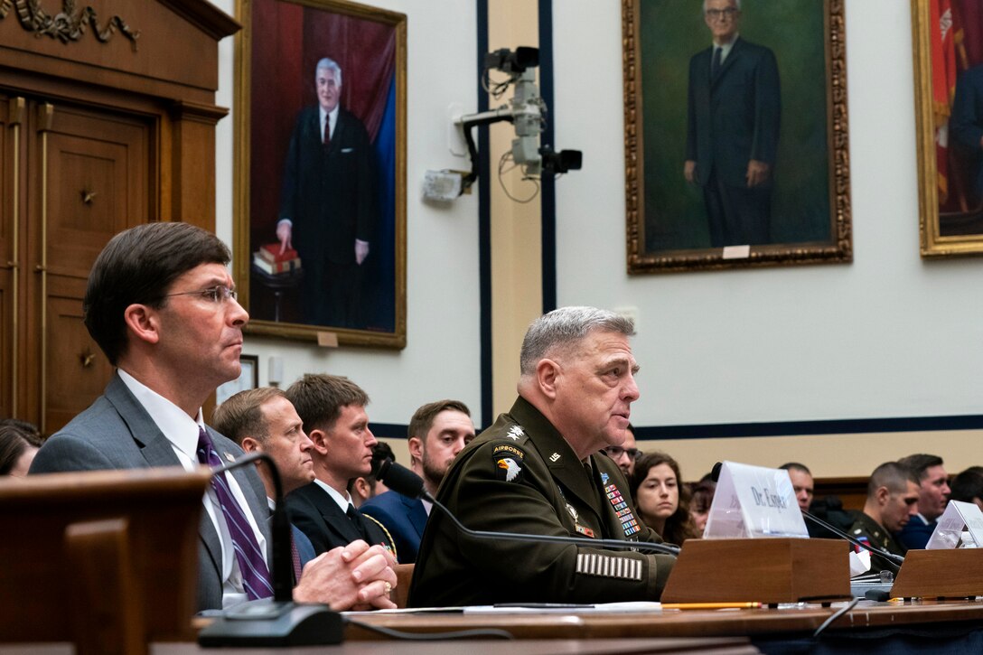 Defense Secretary Dr. Mark T. Esper and Army Gen. Mark A. Milley sit at a table.