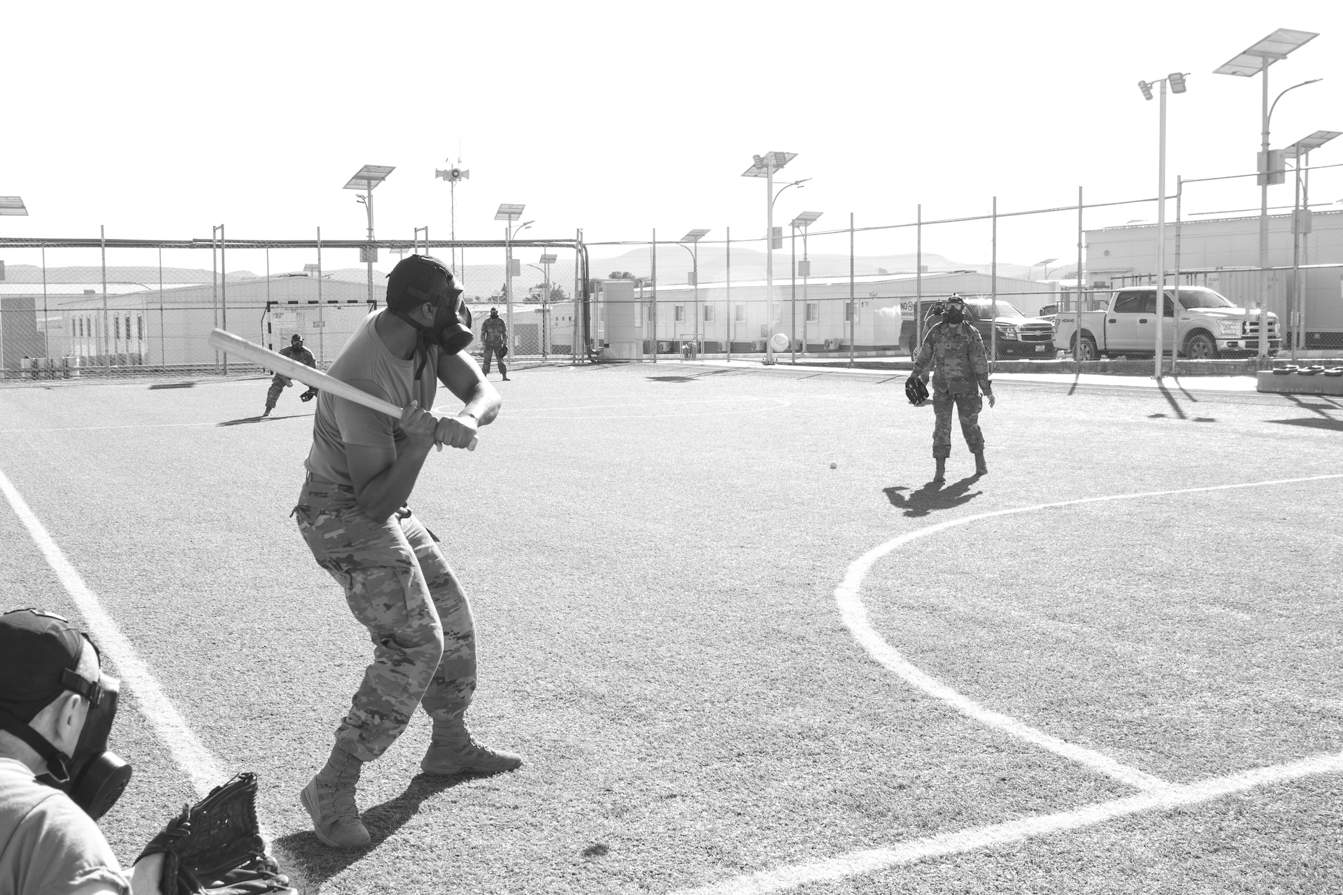 A U.S. Army Soldier, with 655 Regional Support Group, 316 Sustainment Command (Expeditionary), 377 Theater Sustainment Command, swings at a ball during a game of gas mask baseball Feb. 12, 2020 at Joint Training Center-Jordan, paying tribute to former service members who used the sport to train for chemical warfare during WWI. We still have the greatest Army in the world. We serve the people of the United States and we are going to protect them with our lives if that is what it comes to. (U.S. Army photo by Sgt. 1st Class Shaiyla B. Hakeem)