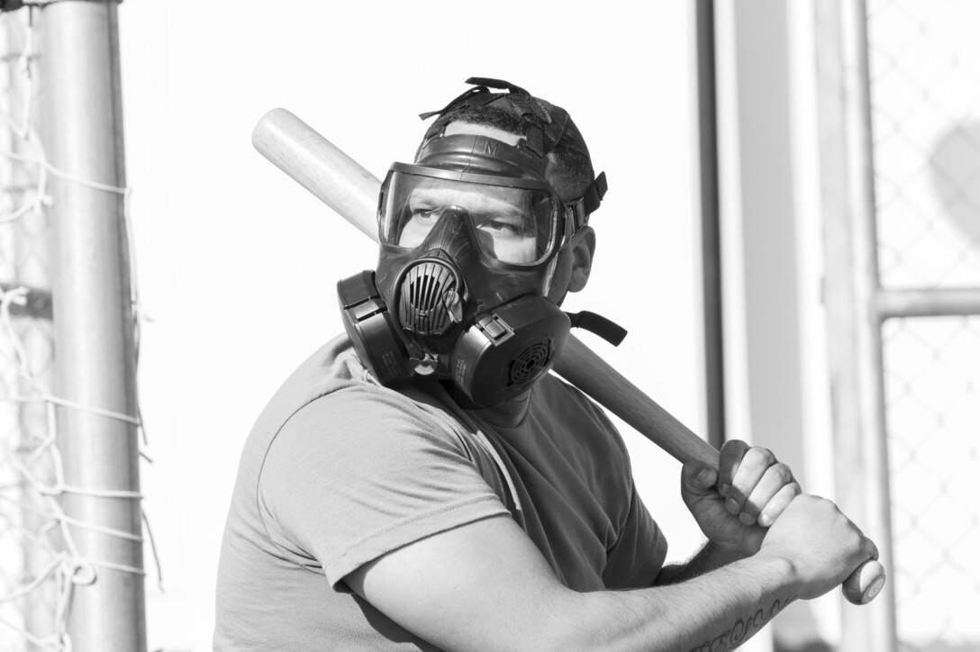 A U.S. Army Soldier, with 655 Regional Support Group, 316 Sustainment Command (Expeditionary), 377 Theater Sustainment Command, prepares to hit a ball during a game of gas mask baseball Feb. 12, 2020 at Joint Training Center-Jordan, paying tribute to former service members who used the sport to train for chemical warfare during WWI. We still have the greatest Army in the world. We serve the people of the United States and we are going to protect them with our lives if that is what it comes to. (U.S. Army photo by Sgt. 1st Class Shaiyla B. Hakeem)