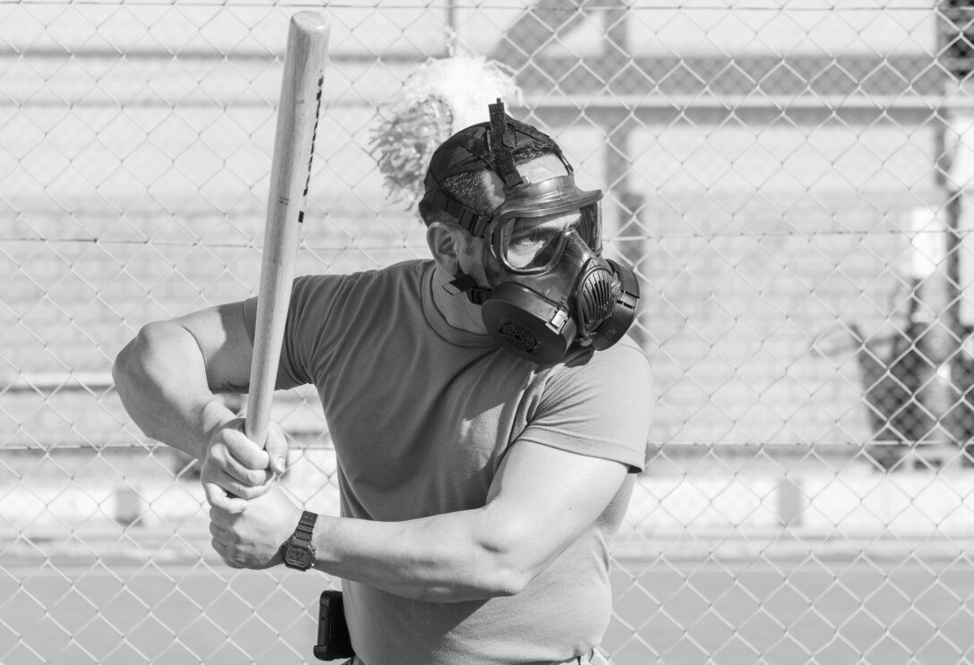 A U.S. Army Soldier, with 655 Regional Support Group, 316 Sustainment Command (Expeditionary), 377 Theater Sustainment Command, prepares to hit a ball during a game of gas mask baseball Feb. 12, 2020 at Joint Training Center-Jordan, paying tribute to former service members who used the sport to train for chemical warfare during WWI. We still have the greatest Army in the world. We serve the people of the United States and we are going to protect them with our lives if that is what it comes to. (U.S. Army photo by Sgt. 1st Class Shaiyla B. Hakeem)