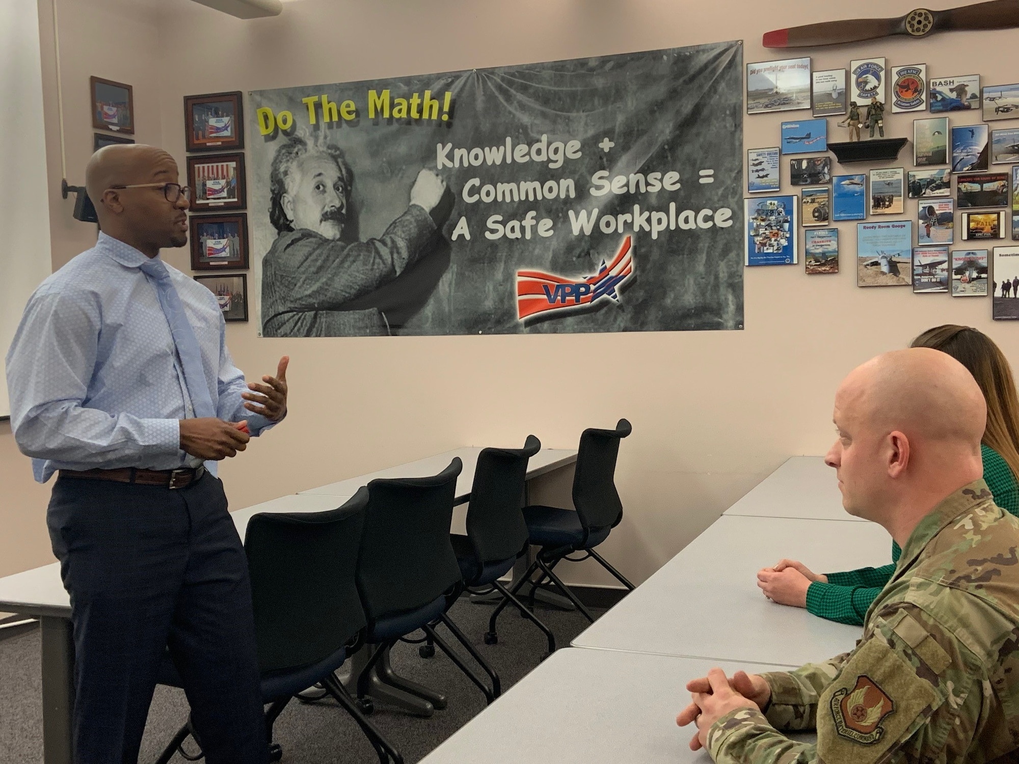 88th Air Base Wing occupational safety manager Kelley Hill, left, discusses safety programs with his staff. Hill, who served the Air Force both in uniform and as a civilian, understands the value of diversity in the workplace and how it develops a strong team. (U.S. Air Force photo/Stacey Geiger)