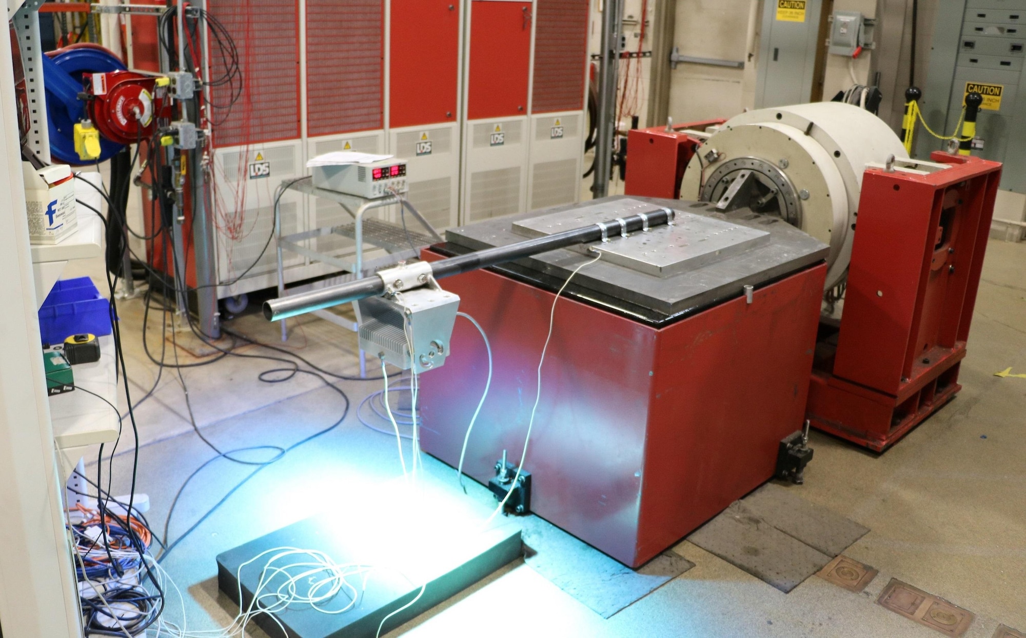 A Maintenance Flood Light, one of the new LED Standard Configuration Advanced Flight Deck Lights that is replacing the legacy incandescent lights on Air Capable Ships, receives shipboard environmental vibration testing.