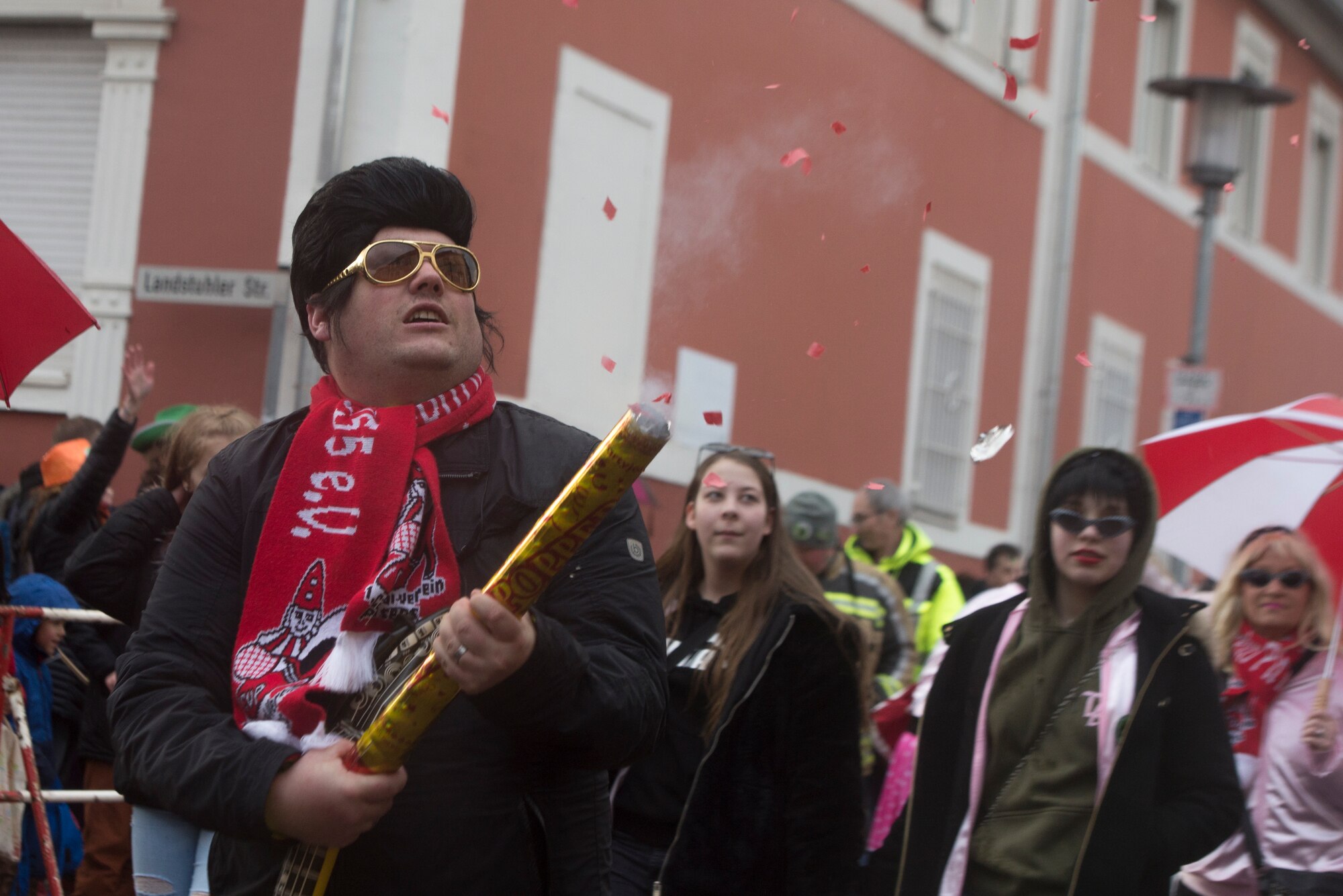 Man fires confetti cannon.