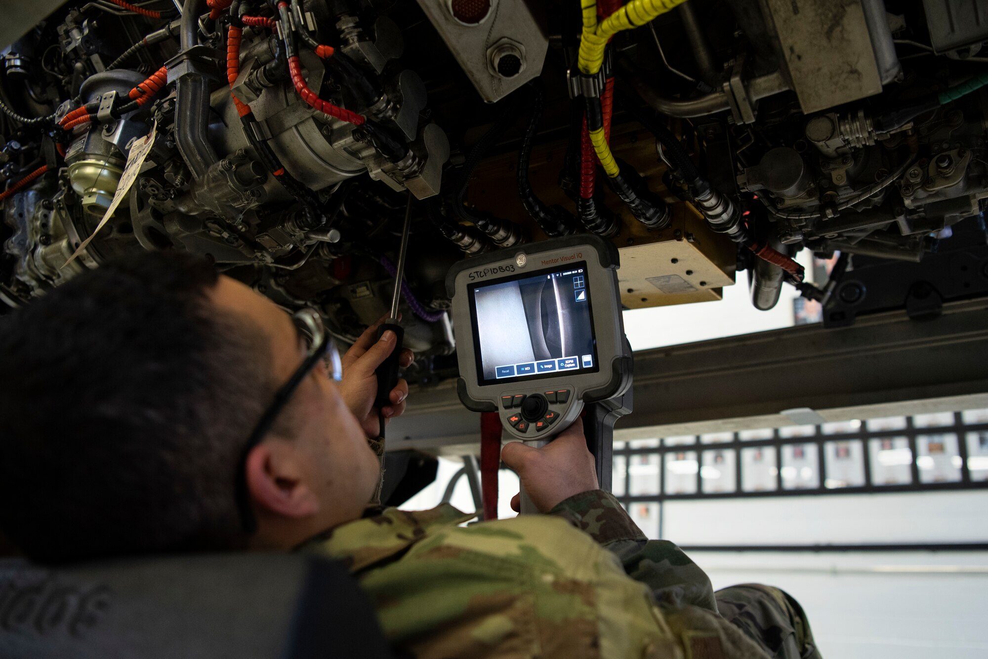 U.S. Air Force Airman 1st Class Cesar Batalla Rivera, 52nd Maintenance Squadron aerospace propulsion journeyman, inspects internal components of a jet engine using a borescope at Spangdahlem Air Base, Germany, Feb. 25, 2020. Batalla Rivera checked the engine compressor for nicks and scratches to prevent potential issues. (U.S. Air Force photo by Airman 1st Class Valerie Seelye)