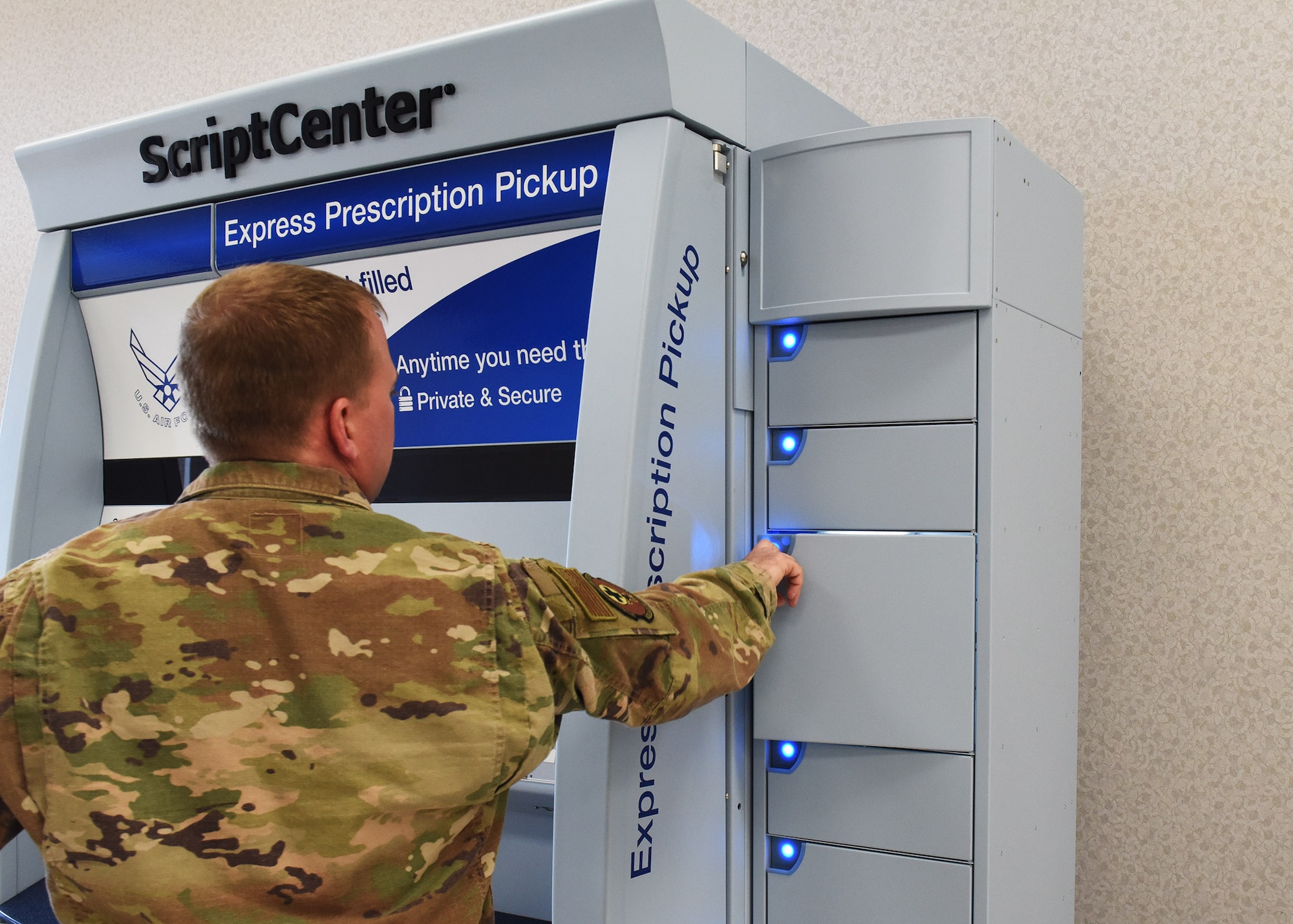 Staff Sgt. Dustin Stevens, 7th Medical Support Squadron pharmacy technician, opens a locker in the ScriptCenter at Dyess Air Force Base, Texas, Feb. 26, 2020.