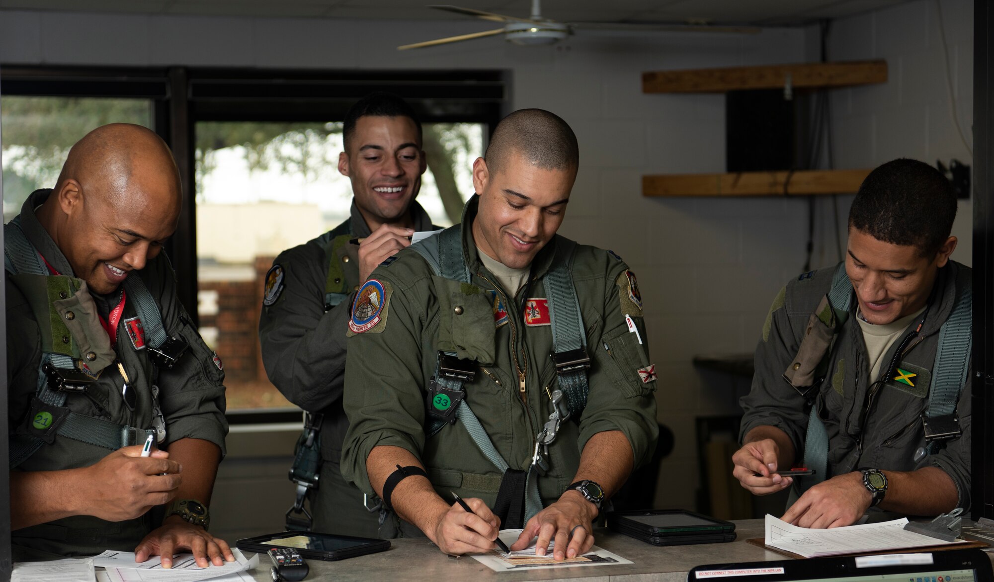 U.S. Air Force pilots, assigned to the 100th Fighter Squadron at the 187th Fighter Wing, Alabama Air National Guard, prepare to fly an all-black training sortie to commemorate Black History Month and honor the Tuskegee Airmen February 18, 2020 at Dannelly Field, Ala. A KC-135 Stratotanker from the 92nd Air Refueling Wing, Fairchild Air Force Base, Wash., also piloted and crewed by black Airmen, refueled the four F-16 Fighting Falcons during the mission. (US Air National Guard photos by Jared Rand)
