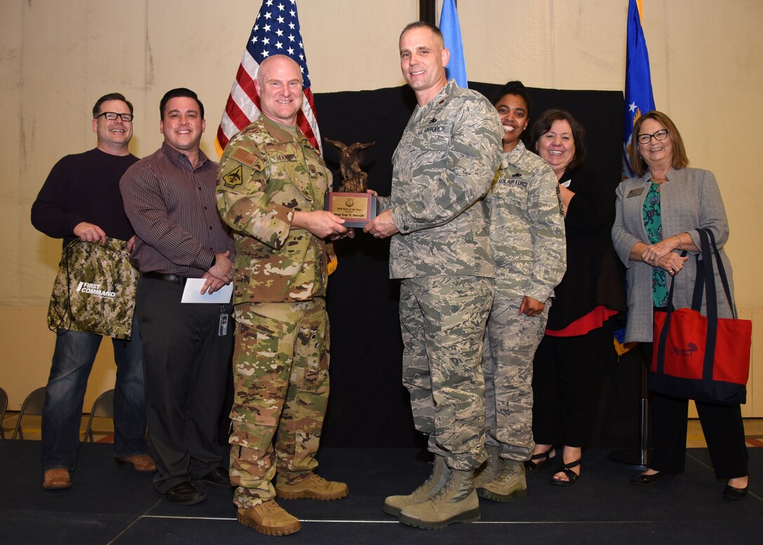 Maj. Randy Starnes, 507th Maintenance Squadron commander, receives the 2019 507th ARW NCO of the Year award on behalf of Staff Sgt. Tray Dorrell, 507th MXS engine mechanic, from Col. Miles Heaslip, 507th ARW commander, during the 2019 Annual Awards Banquet Feb. 8, 2020, at Tinker Air Force Base, Oklahoma. (U.S. Air Force photo by Tech. Sgt. Samantha Mathison)