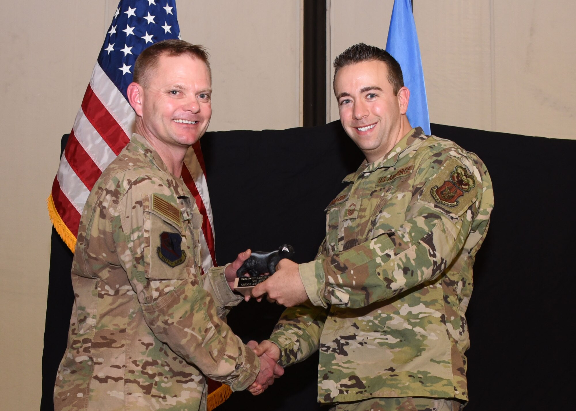 Senior Master Sgt. Justin Malzer, 507th Air Refueling Wing Inspector General Inspections, receives the 2019 507th ARW Wing Staff Honey Badger Trophy from Lt. Col. Patrick Mitchell, 507th ARW executive officer during the 2019 Annual Awards Banquet Feb. 8, 2020, at Tinker Air Force Base, Oklahoma. (U.S. Air Force photo by Tech. Sgt. Samantha Mathison)