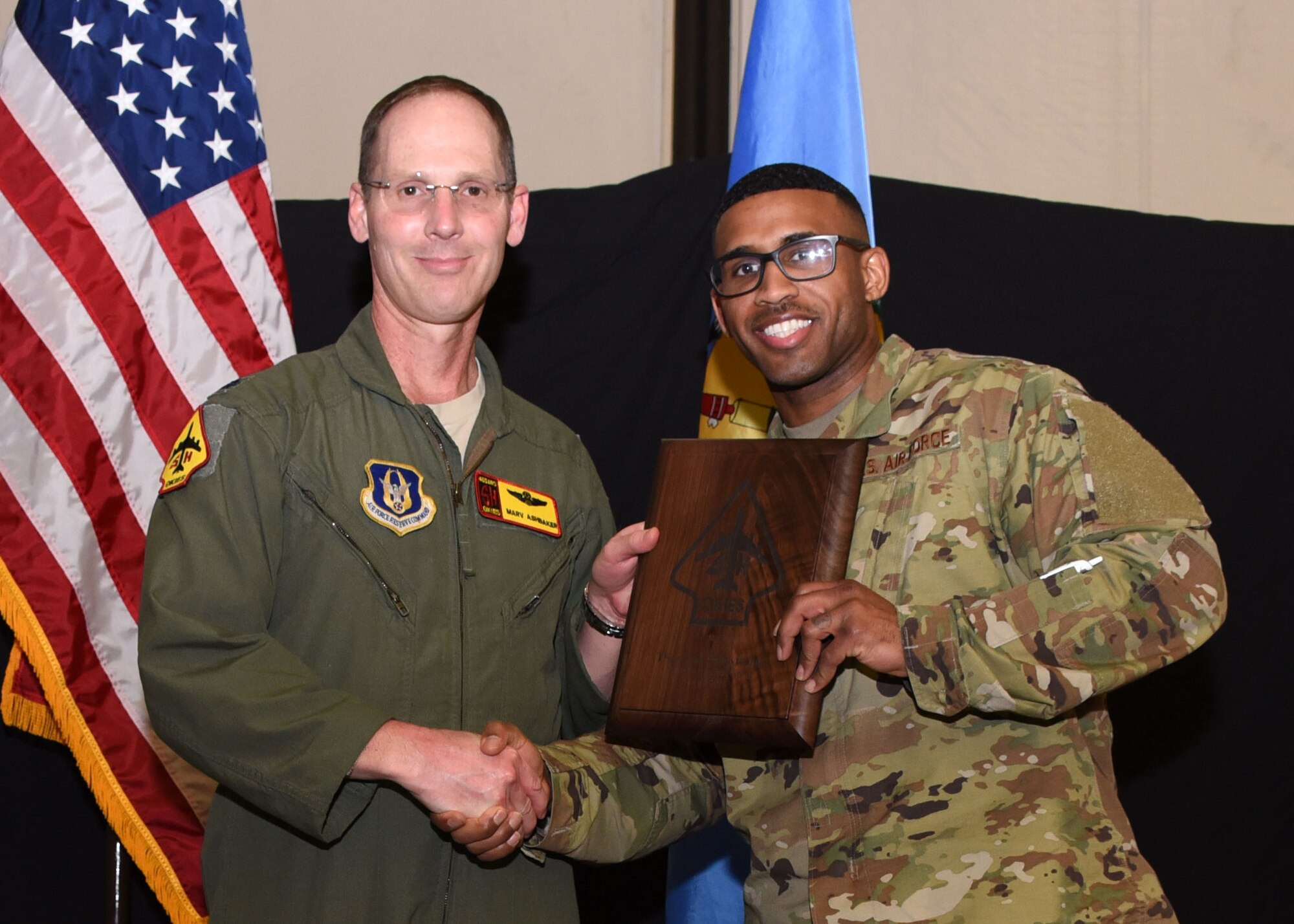 Tech. Sgt. Leon Pennyfeather, 507th Operations Support Squadron, receives the 2019 507th Operations Group Okie MVP award from Lt. Col. Marvin Ashbaker, 465th ARS director of operations, during the 2019 Annual Awards Banquet Feb. 8, 2020, at Tinker Air Force Base, Oklahoma. (U.S. Air Force photo by Tech. Sgt. Samantha Mathison)