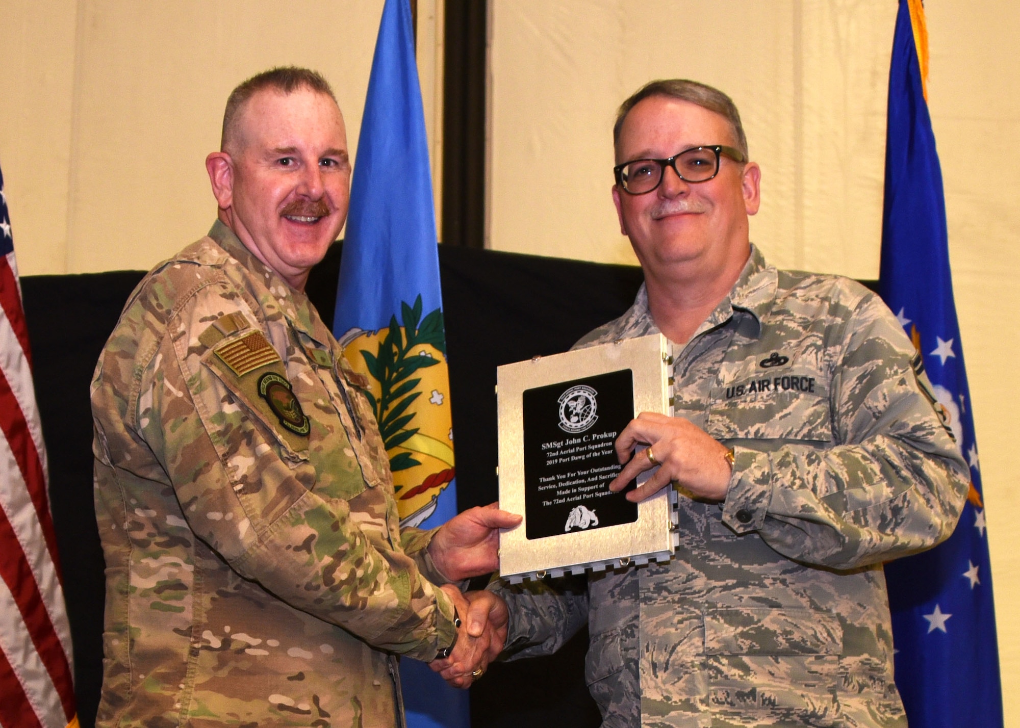 Senior Master Sgt. John Prokup, 507th Aerial Port Squadron, receives the 2019 Port Dawg of the Year award from Lt. Col. Darryl McLean, 72d APS commander, during the 2019 Annual Awards Banquet Feb. 8, 2020, at Tinker Air Force Base, Oklahoma. (U.S. Air Force photo by Tech. Sgt. Samantha Mathison)
