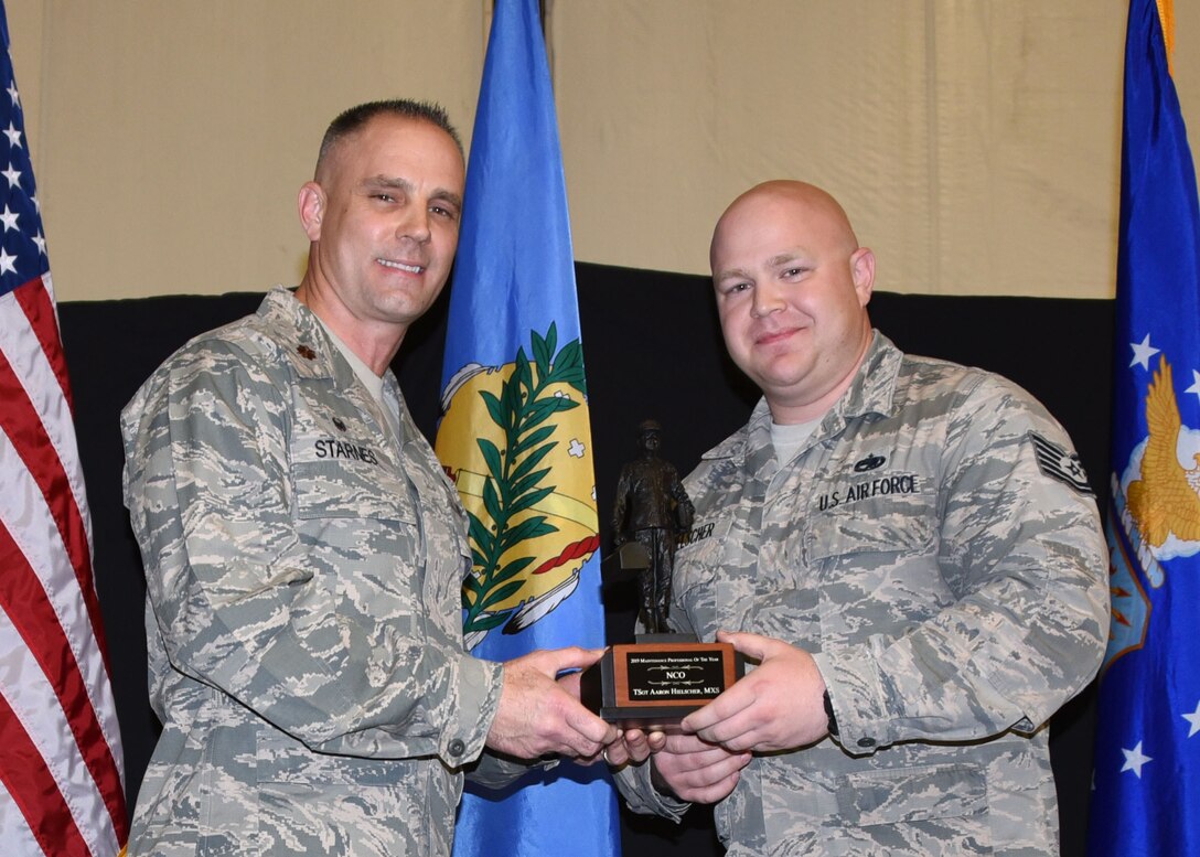 Tech. Sgt. Aaron Hielscher, 507th Maintenance Squadron, receives the 2019 507th MXS Maintenance Professional of the Year award from Maj. Randy Starnes, 507th MXS commander, during the 2019 Annual Awards Banquet Feb. 8, 2020, at Tinker Air Force Base, Oklahoma. (U.S. Air Force photo by Tech. Sgt. Samantha Mathison)