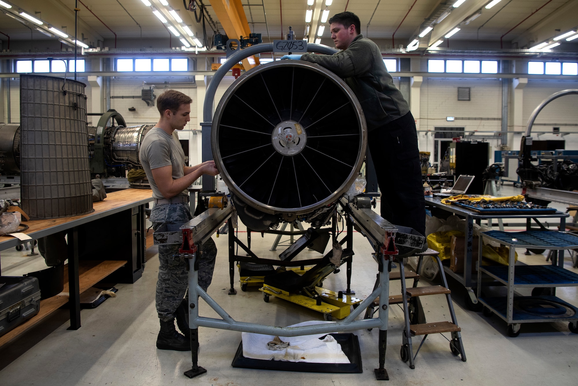 U.S. Air Force Staff Sgt. John Barickman, 52nd Maintenance Squadron aerospace propulsion craftsman, left, and Airman 1st Class Austin Wise, 52nd MXS aerospace propulsion journeyman, install an F110-GE-129 jet engine upper-fan stator case at Spangdahlem Air Base, Germany, Feb. 25, 2020. The 52nd MXS Propulsion Flight is U.S. Air Forces in Europe's sole centralized repair facility for F110 engines and is in charge of engine inspection, teardown, buildup, and testing. (U.S. Air Force photo by Airman 1st Class Valerie Seelye)