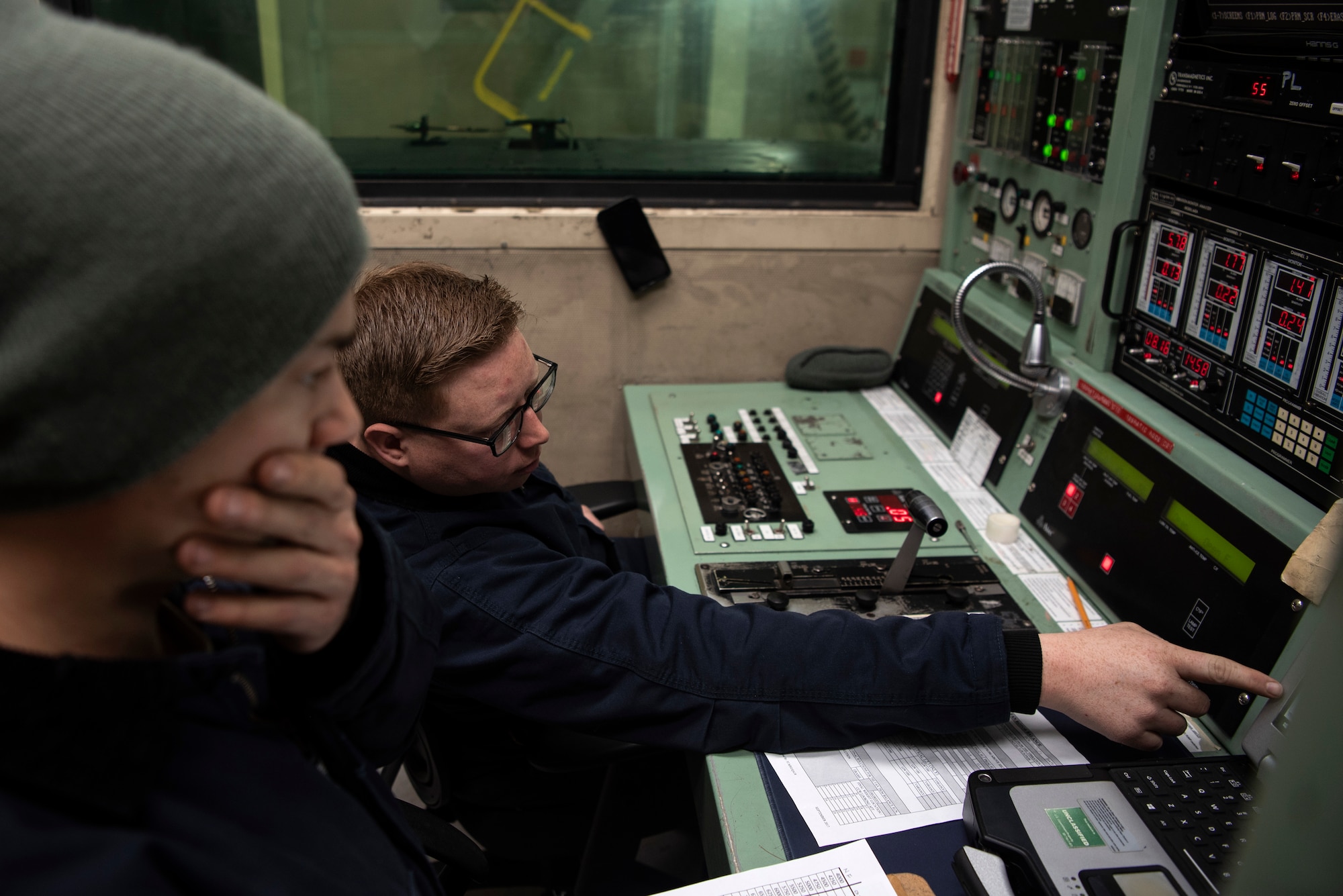 U.S. Air Force Staff Sgt. Dustin Gaskins, 52nd Maintenance Squadron aerospace propulsion craftsman, left, and Tech. Sgt. Aaron Filkins, 52nd MXS test cell shift supervisor, monitor engine performance during test operations at Spangdahlem Air Base, Germany, Feb. 25, 2020. The test cell is used to make sure jet engines are in quality-working order after being built or repaired. (U.S. Air Force photo by Airman 1st Class Valerie Seelye)