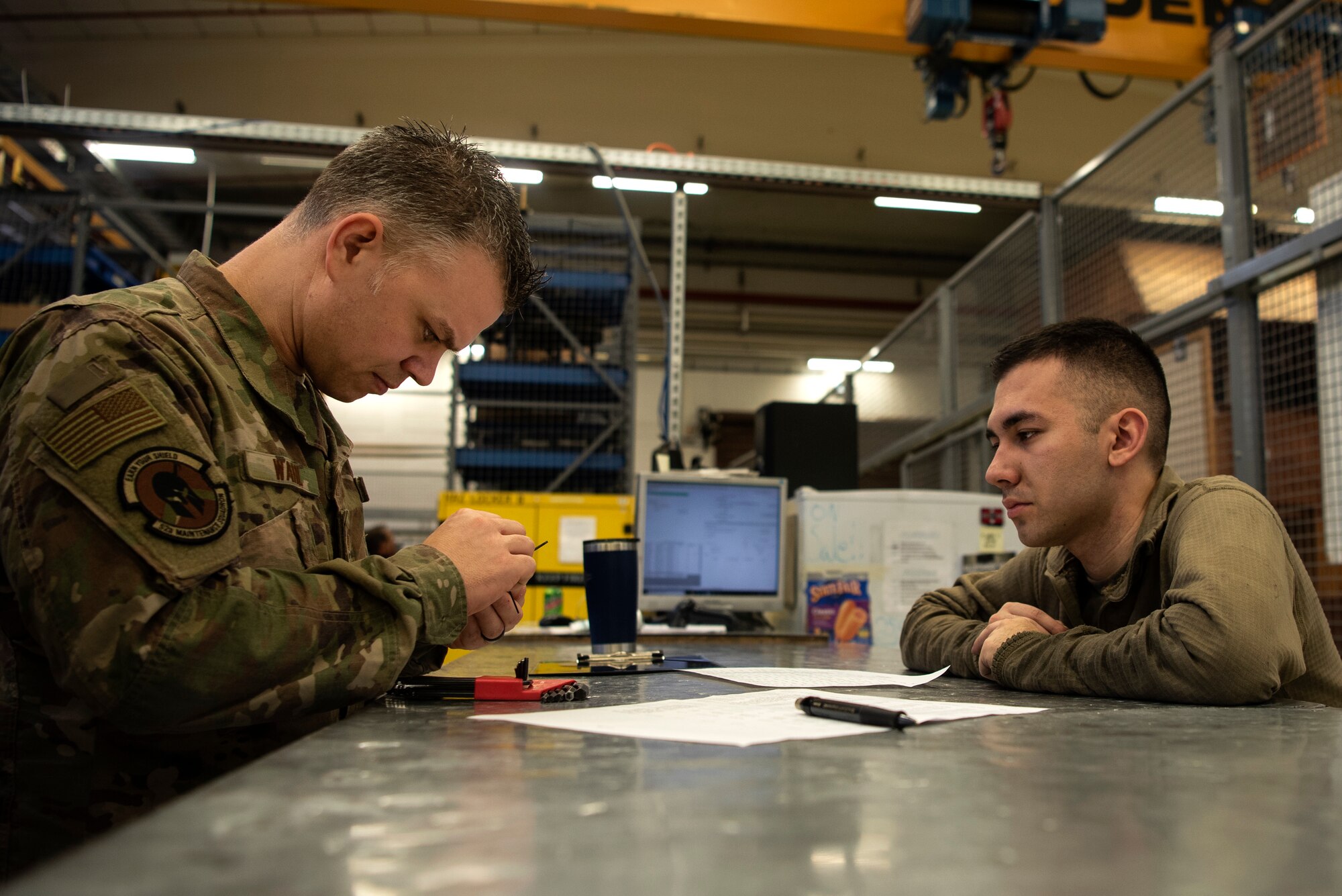 U.S. Air Force Master Sgt. Charles Wahl, 52nd Maintenance Squadron support section chief, left, and Senior Airman Ryan Cruz, 52nd MXS aerospace propulsion journeyman, right, inspect equipment prior to it being issued from the support section at Spangdahlem Air Base, Germany, Feb. 25, 2020. The 52nd MXS Propulsion Flight support section provides parts for jet engine buildup and repair. (U.S. Air Force photo by Airman 1st Class Valerie Seelye)