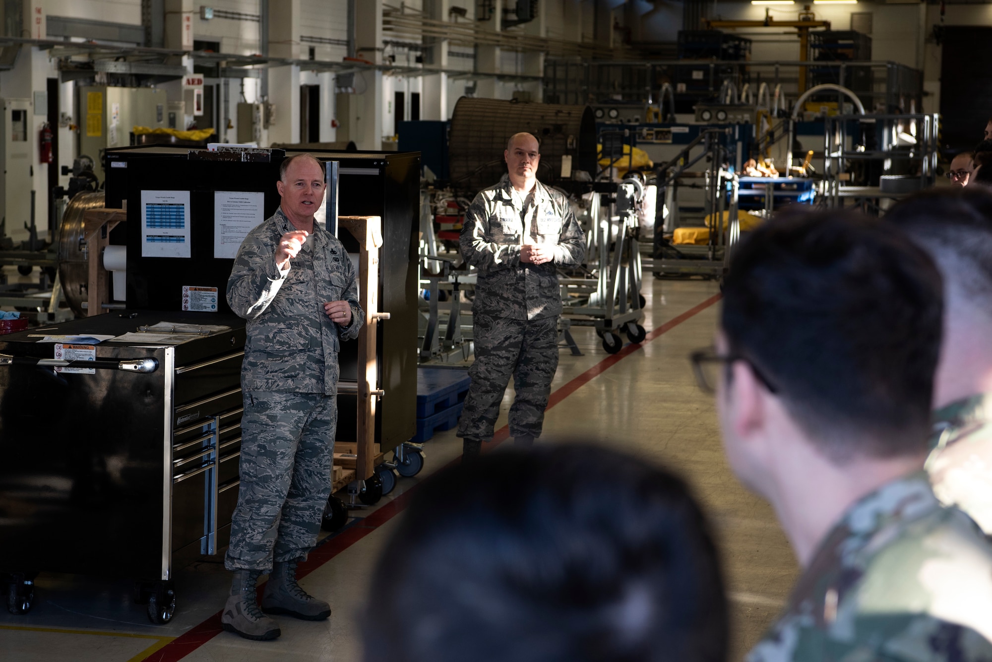 U.S. Air Force Col. Timothy Trimmell, 52nd Maintenance Group commander, left, speaks to 52nd MXS Propulsion Flight Airmen about their accomplishments at Spangdahlem Air Base, Germany, Feb. 6, 2020. Trimmell congratulated the Airmen on winning the Air Force Chief of Safety: Aviation Maintenance Safety Award. The flight is responsible for building and fixing aircraft engines for multiple wings and commands in Europe.  (U.S. Air Force photo by Airman 1st Class Valerie Seelye)