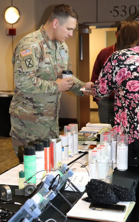 Maj. Brian Hewko, executive officer for the 615th Aviation Support Battalion, 1st Air Cavalry Brigade, Fort Hood, Texas, talks with AMCOM corrosion specialists during the AMCOM 101 for Aviation forum, Feb. 19-20. Corrosion prevention was a hot topic during the forum, both in panel discussions and during breaks.