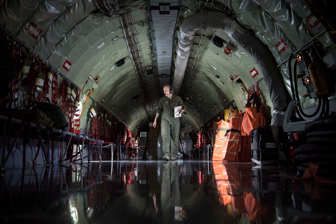 An airman walks through an aircraft.