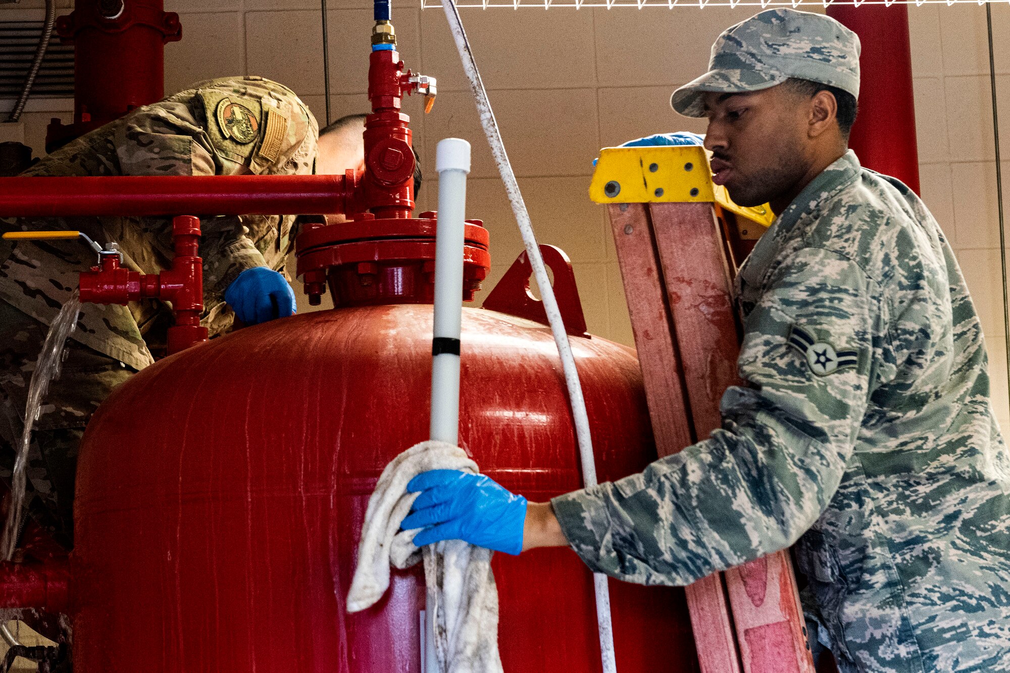 Photo of Airman cleaning a sight tube.