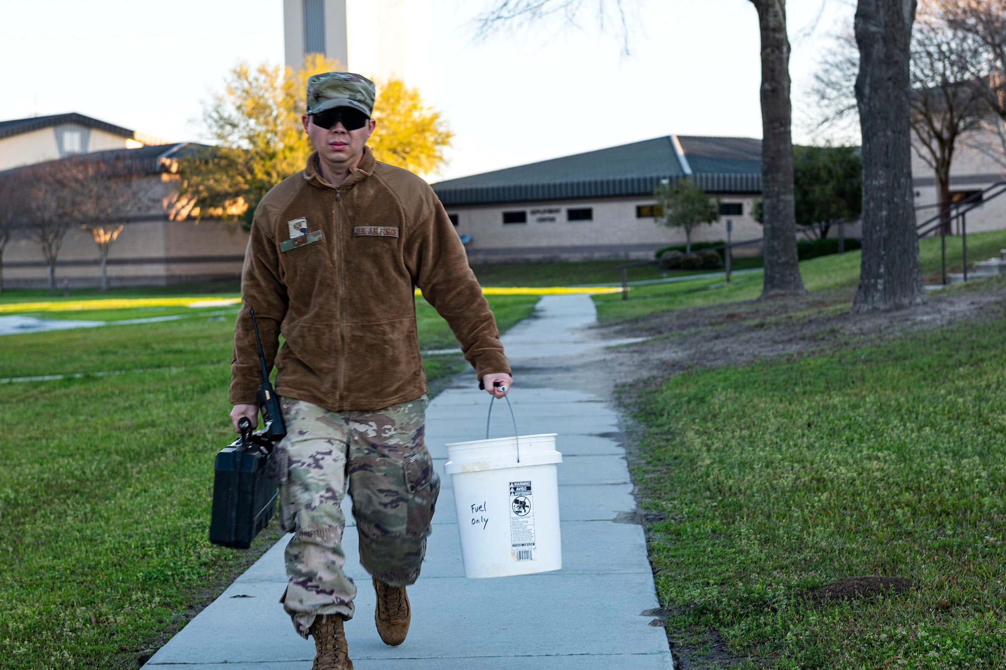 Photo of Airman walking to a job site.