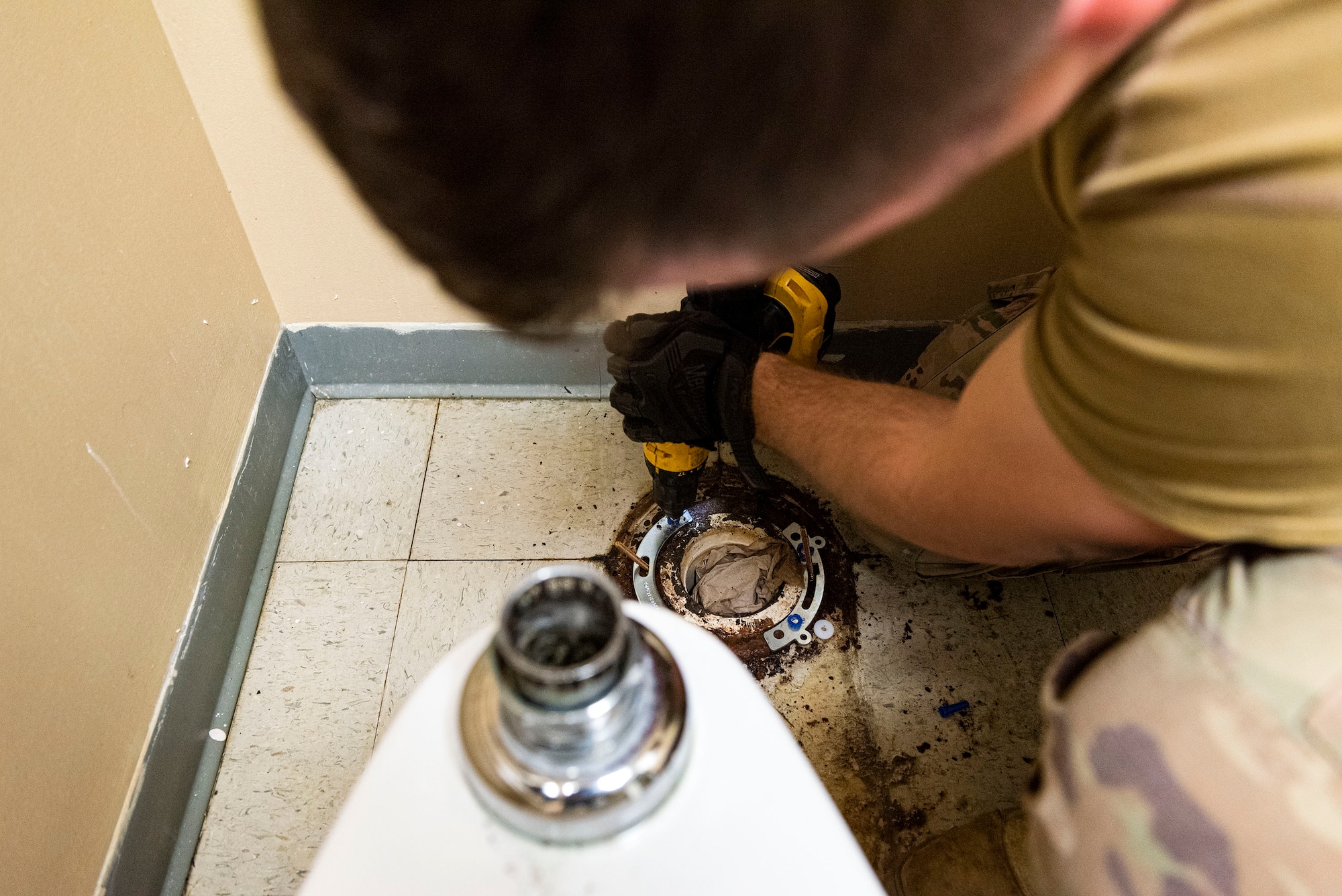 Photo of Airman drilling holes into a flange.