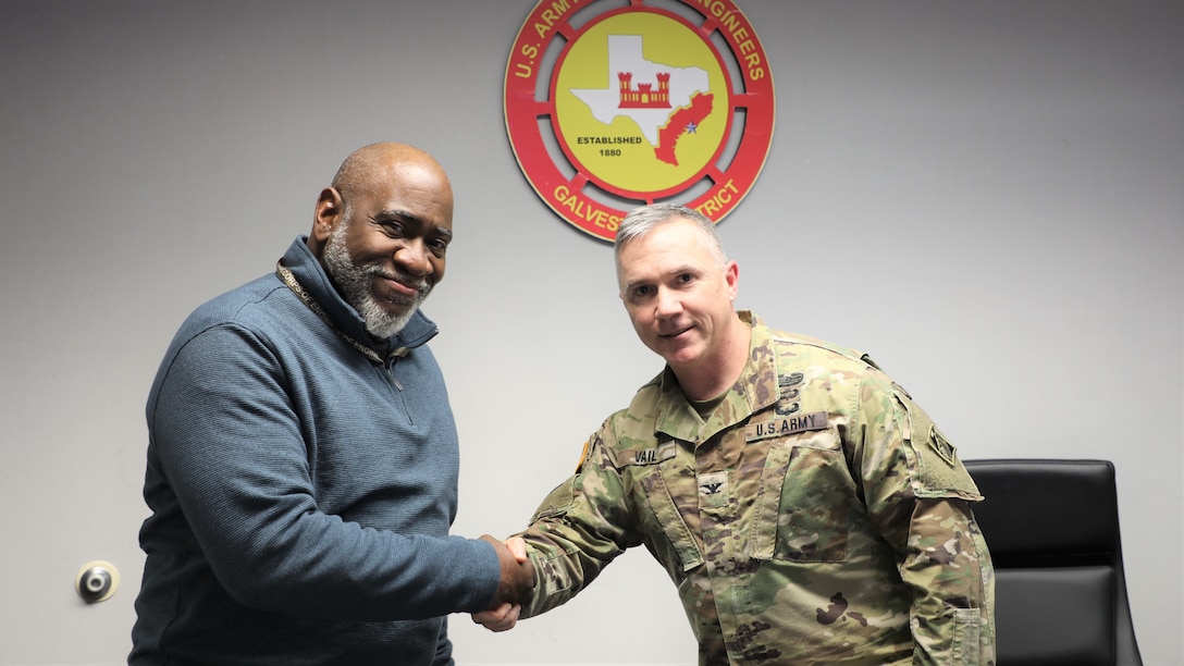 Brooks Hubbard, public affairs specialist from USACE Los Angeles District receives a commander's coin for his work on the Coastal Protection and Restoration Feasibility Study during his 149 day duty to the Galveston District.