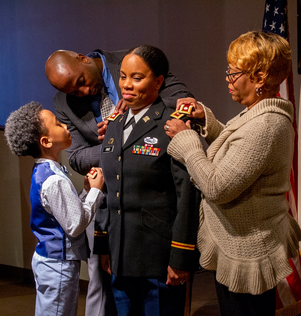 Husband Chris Price, son Jeremiah and mother, Doris Dorsey, pin the rank of Lieutenant Colonel on Danielle Price during a ceremony Feb. 27 at the Illinois State Military Museum, Springfield, Illinois.