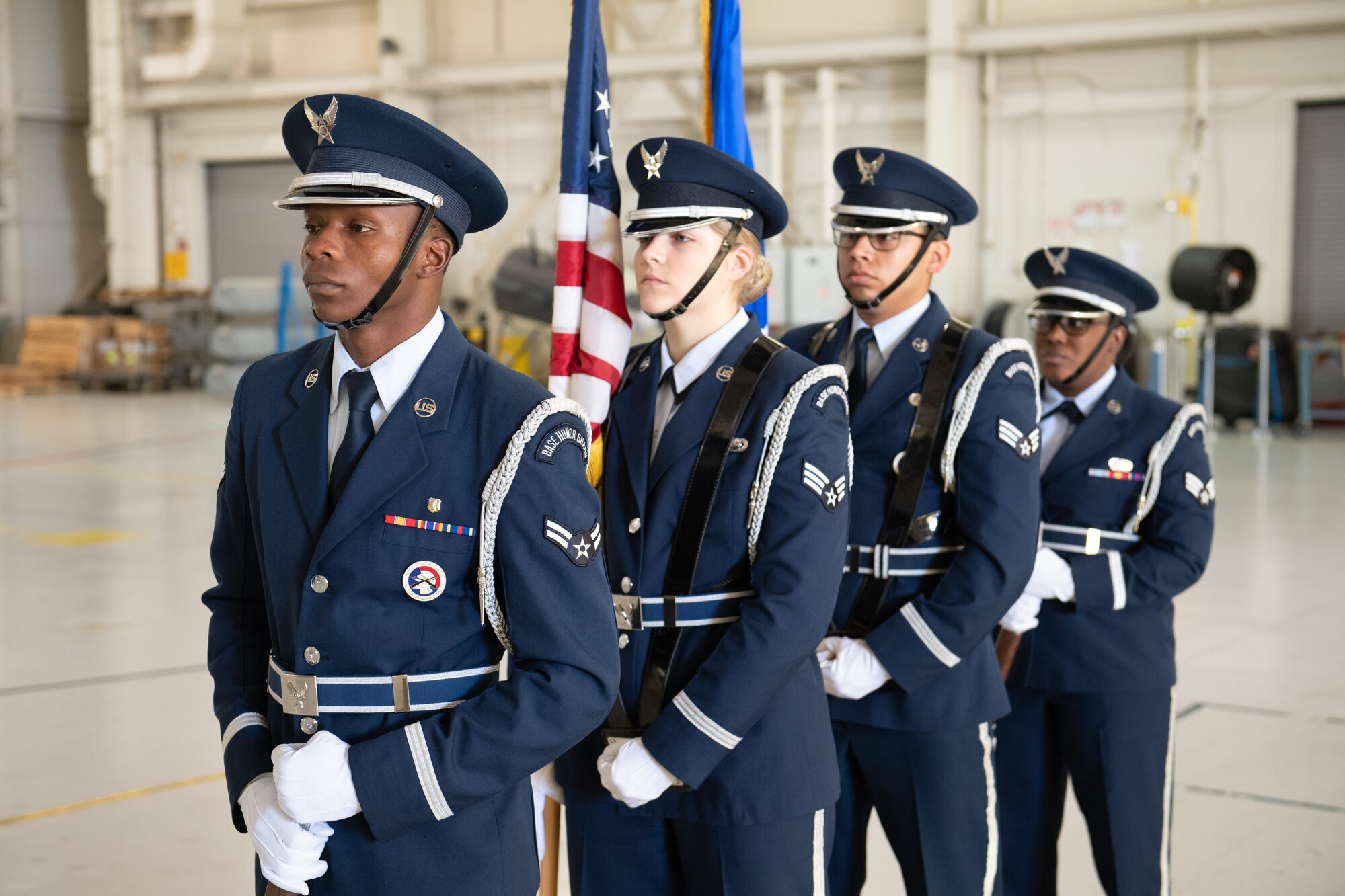Airmen in a color guard stand