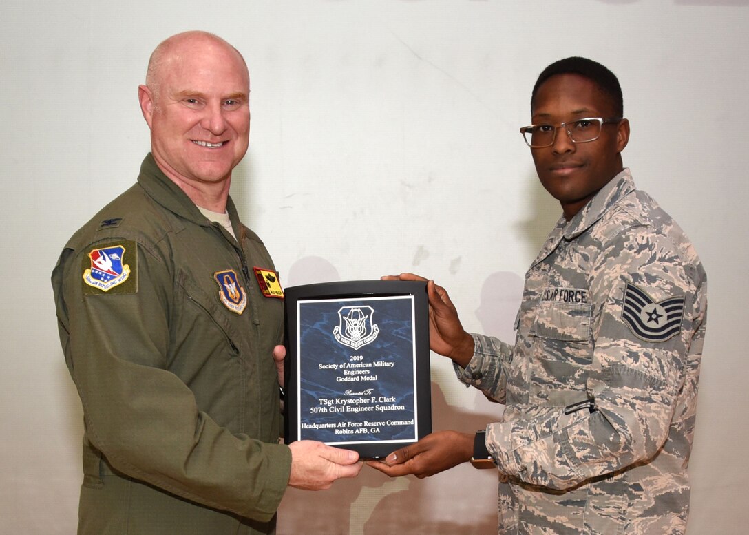 Tech. Sgt. Krystopher Clark, 507th Civil Engineer Squadron, receives the 2019 Society of American Military Engineers Goddard Medal from Col. Miles Heaslip, 507th Air Refueling Wing commander, Feb. 9, 2020, at Tinker Air Force Base, Oklahoma. (U.S. Air Force photo by Tech. Sgt. Samantha Mathison)