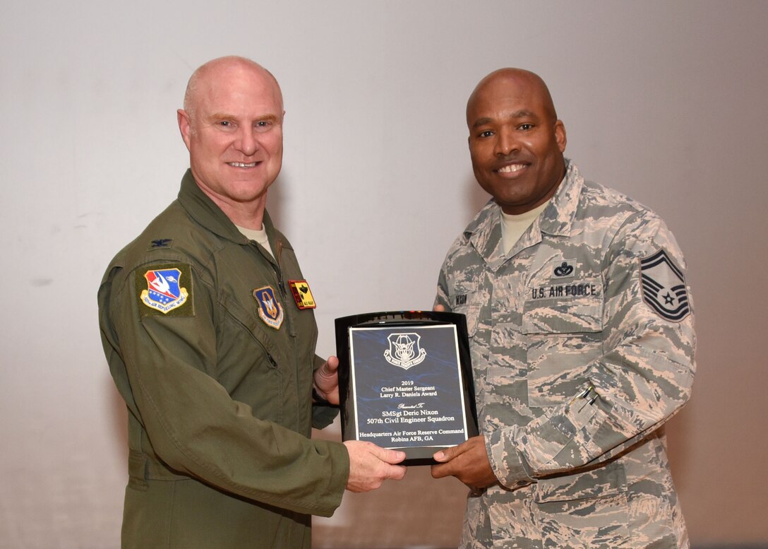 Senior Master Sgt. Deric Nixon, 507th Civil Engineer Squadron, receives the 2019 Chief Master Sergeant Larry R. Daniels Award from Col. Miles Heaslip, 507th Air Refueling Wing commander, Feb. 9, 2020, at Tinker Air Force Base, Oklahoma. (U.S. Air Force photo by Tech. Sgt. Samantha Mathison)