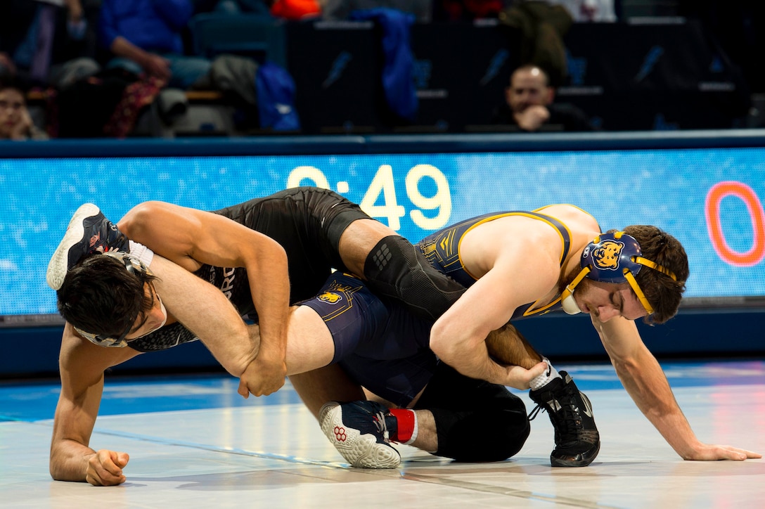 A U.S. Academy Air Force wrestler grapples with a competitor.