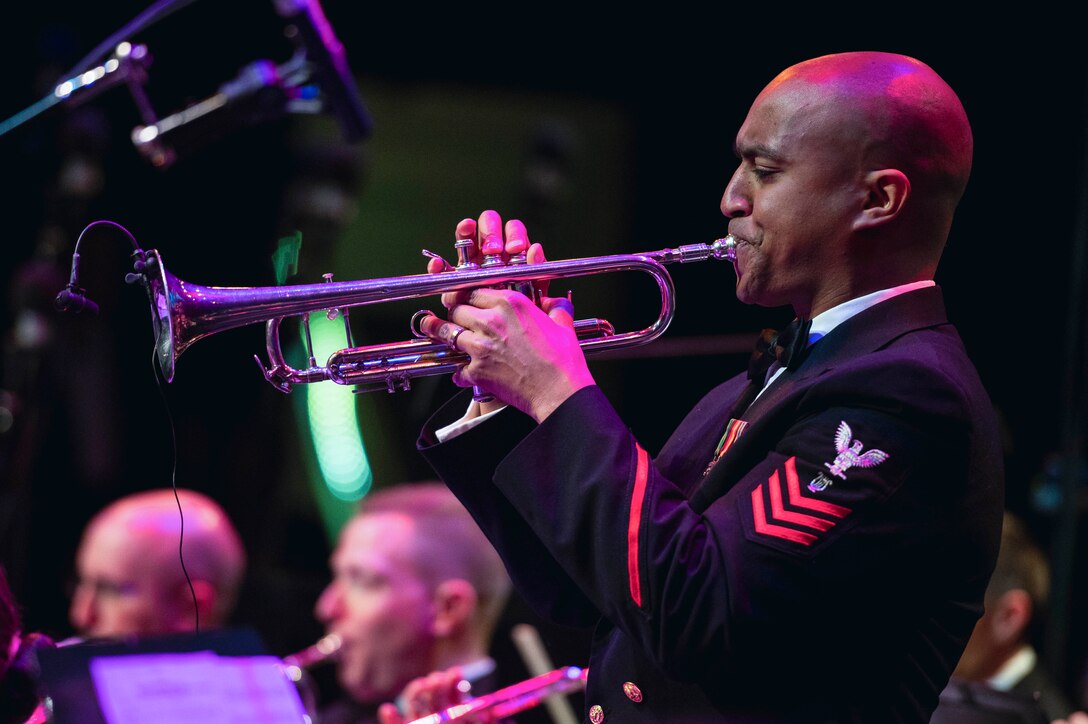 A sailor plays an instrument.